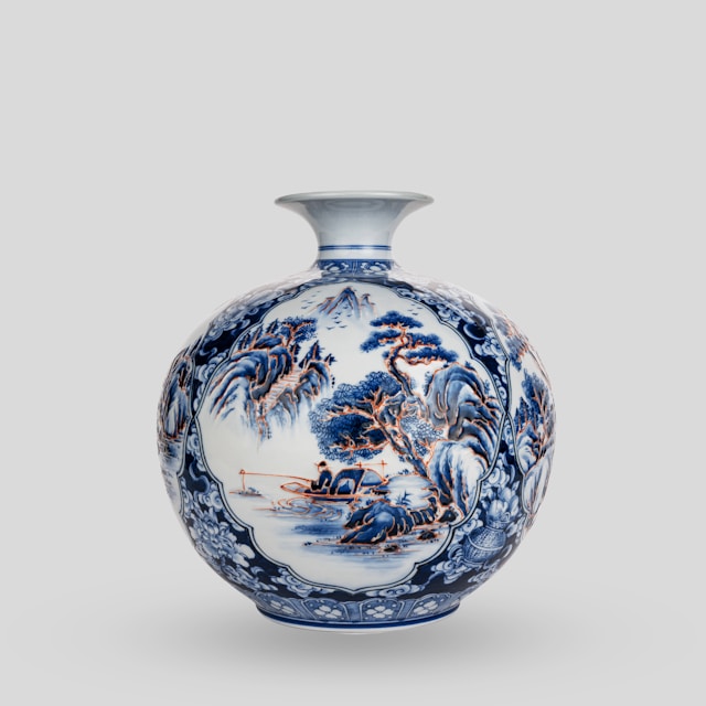 A blue and white vase sitting on top of a table